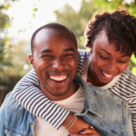 two people identifying as a man and a woman are smiling with a sunny dappled day in the background - what are the body fluids that transmit hiv